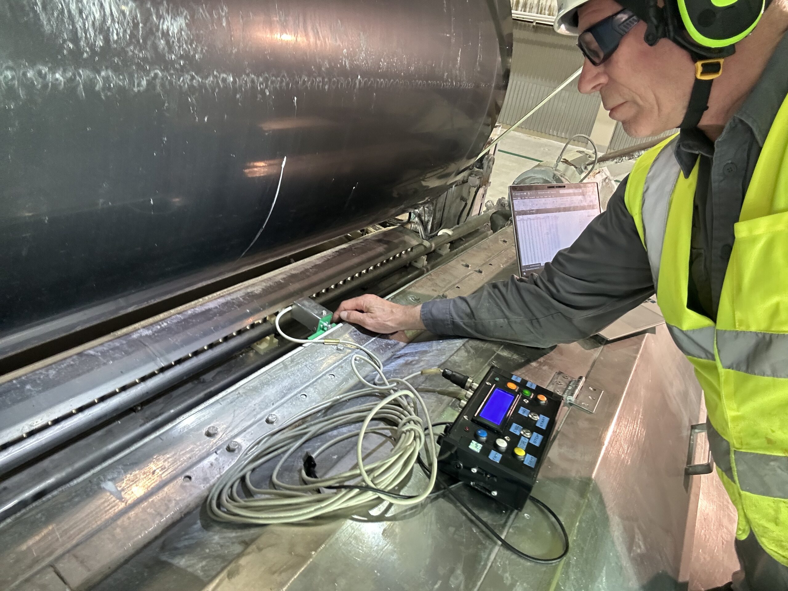 Paper machine audit measurement during coating process inspection.